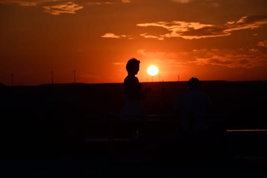 View of outlines of people at the sunset in Bottrop, Germany in Ruhr area