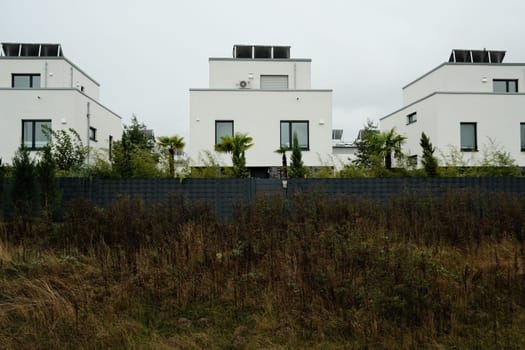 Beautiful view of modern residential houses with palm trees in front in Germany