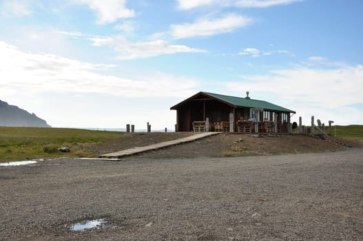View of a house in a field on a beautiful day in Iceland