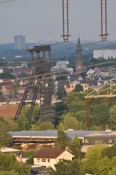 Vertical shot of high voltage power lines over a background of the Ruhr area, NRW, Germany