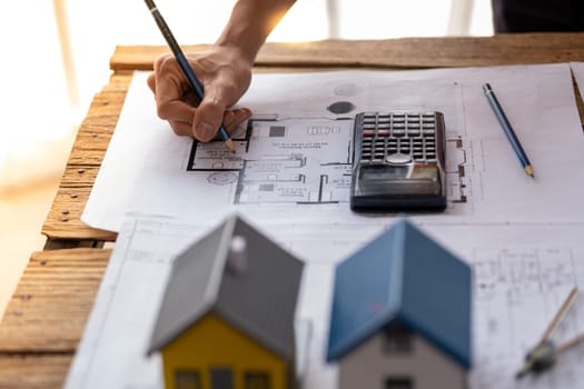 engineer are helping to design work on blueprints, engineer people meeting working and pointing at a paper, professional engineer and architect are drafting a constuction house room building. High quality photo