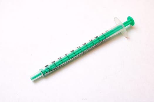 Large medical syringe on a gray background close up