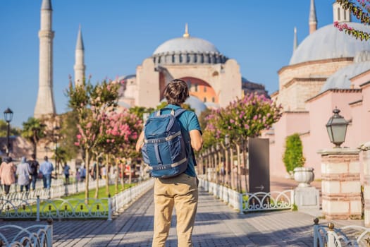 Man enjoy beautiful view on Hagia Sophia Cathedral, famous islamic Landmark mosque, Travel to Istanbul, Turkey. Sunny day architecture and Hagia Sophia Museum, in Eminonu, istanbul, Turkey. Turkiye.