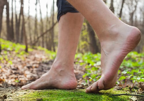 Lifestyle barefoot walk on grass in forest man