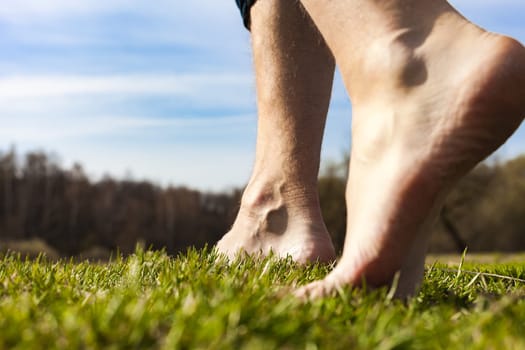Lifestyle barefoot walk on grass in willage men