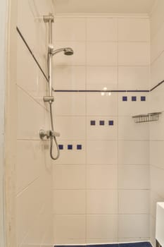 a bathroom with blue tiles on the walls and floor, including a white toilet in the shower stall door is open
