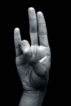 Prithvi Mudra is demonstrated by a male hand isolated on black background.
