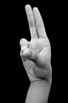 Shot of a human hand showing prana mudra isolated on black background.