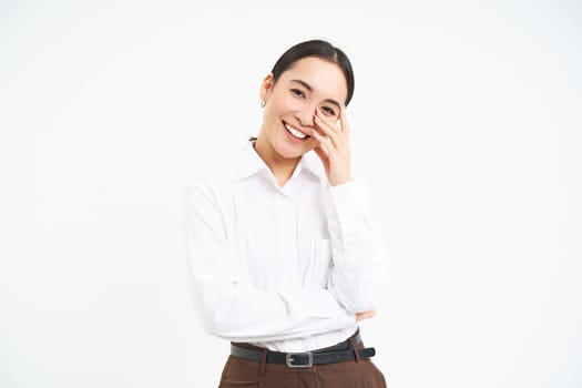Wellbeing and workplace. Smiling happy asian saleswoman, office manager laughing and looking joyful, isolated over white background.
