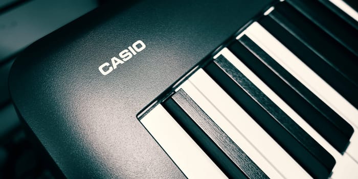 Ryazan, Russia - February 11, 2023: Casio logo on a digital piano. Casio Computer Co., Ltd. is a Japanese multinational electronics manufacturing corporation. Selective focus