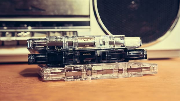 Vintage compact cassettes on the background of a tape recorder