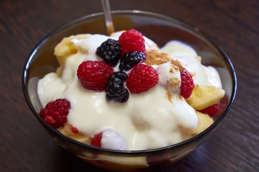 Fruit summer salad in a transparent bowl