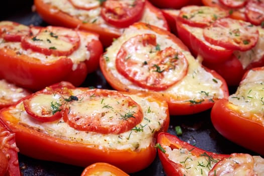 Baked stuffed red bell peppers closeup. Red peppers stuffed with meat and rice