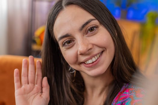 POV of Caucasian woman blogger taking selfie on smartphone, communicating video call online with social media subscribers followers, recording vlog stories. Young girl at home apartment room on couch