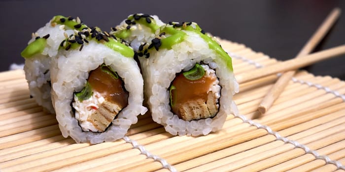 Traditional Japanese food. Sushi rolls on the bamboo mat