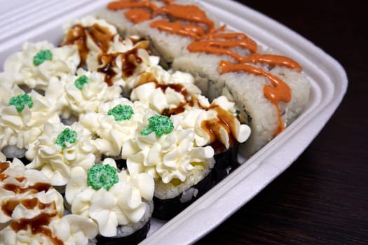 Sushi delivery. Different types of sushi in plastic packaging close-up