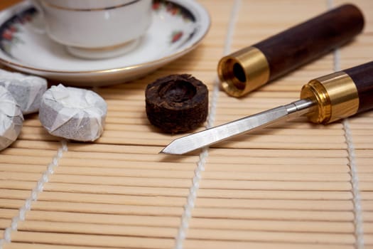 Pu-erh tea knife on a bamboo mat. Tea ceremony