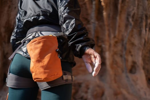 The hand of a young girl with white powder, magnesia close-up, a woman is engaged in active sports, prepares for training, for outdoor climbing.