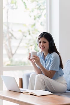 Attractive Asian woman resting comfortable living room and using laptop computer, Relax, Sofa, Lifestyle.