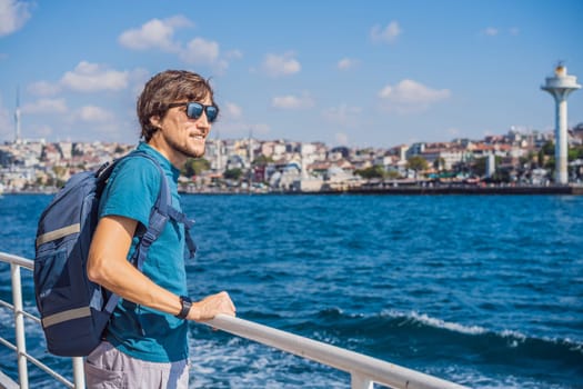 Happy man enjoying the sea from ferry boat crossing Bosphorus in Istanbul. Summer trip to Istanbul.