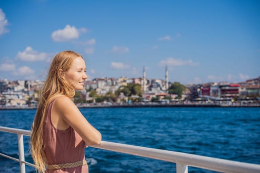Happy woman enjoying the sea from ferry boat crossing Bosphorus in Istanbul. Summer trip to Istanbul.