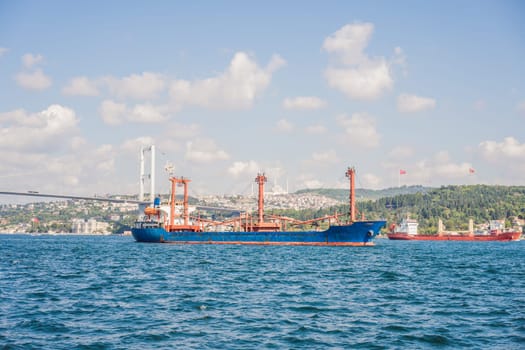 Fatih Sultan Mehmet Bridge Second bridge in Istanbul, Bosphorus with a magnificent looking cargo ship.