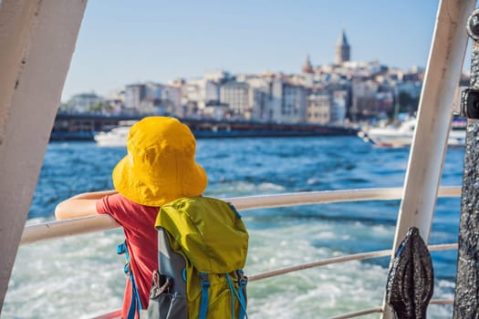 Happy boy enjoying the sea from ferry boat crossing Bosphorus in Istanbul. Summer trip to Istanbul. Traveling with kids concept.