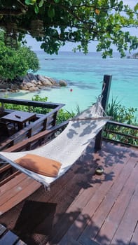 Hammock at the beach of Koh Lipe Island Southern Thailand with turqouse colored ocean and white sandy beach at Ko Lipe.