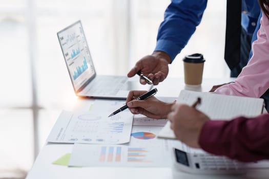 Close up of Diverse colleagues gather brainstorm discuss financial statistics at office meeting. finance, teamwork, Big data Graphs Charts concept.