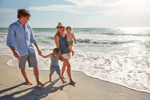 Family makes summer fun. a young family enjoying a summer day out at the beach