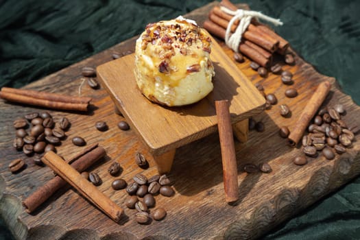 Chocobon (Soft chocolate bun) topped with rich cream cheese frosting and Cinnamon with Coffee beans on wooden with dark background. Selective focus.