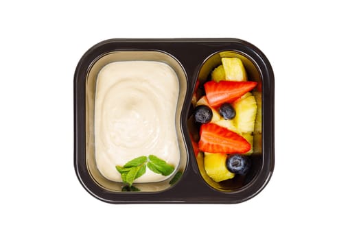 Dessert of applesauce, pineapple and strawberries in a plastic container on a white background. High quality photo