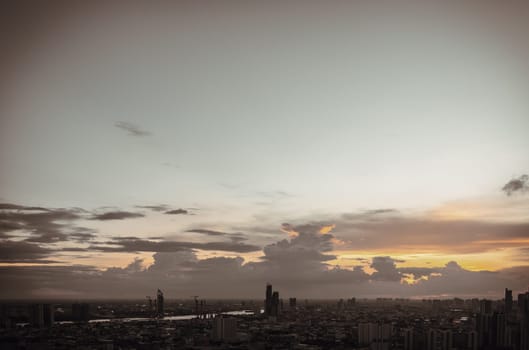 Bangkok, Thailand - Aug 14, 2022 - Gorgeous scenic of the sunset with cloud on the sky over large metropolitan city in Bangkok. Nice city view, Space for text, No focus, specifically.