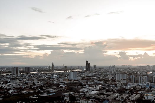 Bangkok, Thailand - Aug 14, 2022 - Gorgeous scenic of the sunset with cloud on the sky over large metropolitan city in Bangkok. Nice city view, Space for text, No focus, specifically.