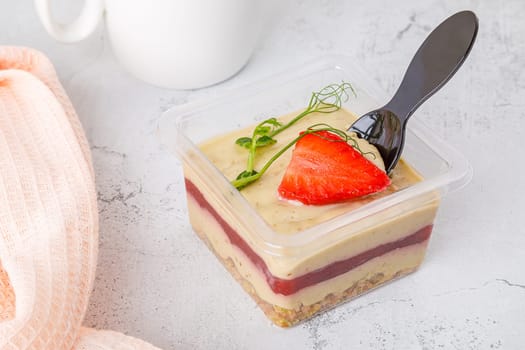 Sweet dessert of cream muesli jam and strawberries on a concrete background. High quality photo