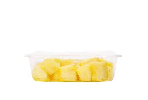 Fruit salad with pineapple in a plastic container on a white background. High quality photo