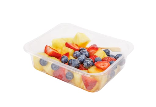 Fruit salad with pineapple, strawberries and blueberries in a plastic container on a white background. High quality photo