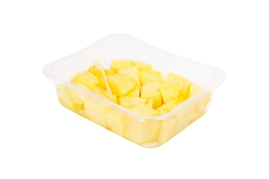 Fruit salad with pineapple in a plastic container on a white background. High quality photo