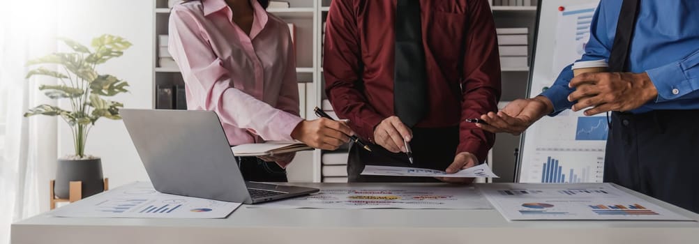 Business People Meeting using laptop computer,calculator,notebook,stock market chart paper for analysis Plans to improve quality next month. Conference Discussion Corporate Concept