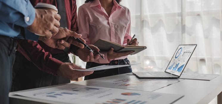 Business People Meeting using laptop computer,calculator,notebook,stock market chart paper for analysis Plans to improve quality next month. Conference Discussion Corporate Concept