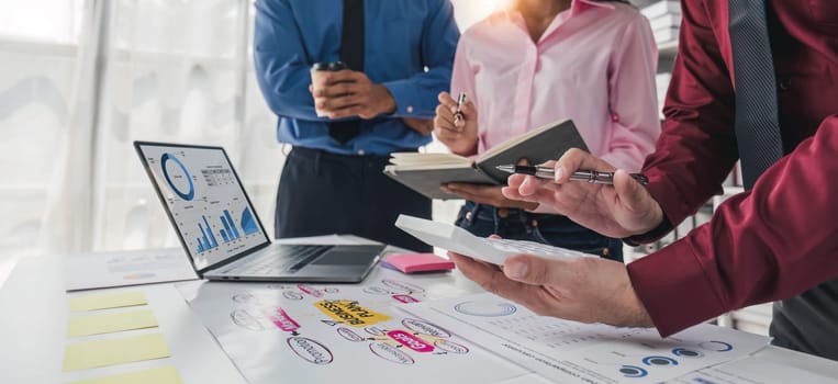 Business People Meeting using laptop computer,calculator,notebook,stock market chart paper for analysis Plans to improve quality next month. Conference Discussion Corporate Concept