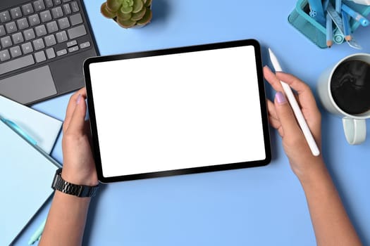 Above view woman holding stylus pen and digital tablet. Blank screen for advertise text.