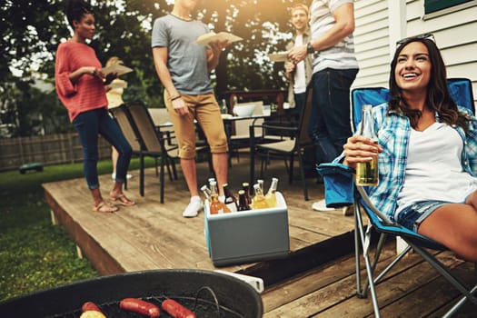 Now this what summer is all about. a group of friends having a barbecue in the yard