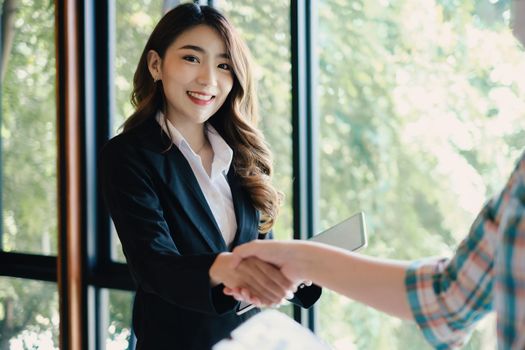 Business woman handshake for the new agreement after sign in agreement contract with work together.