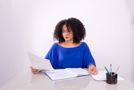 Concentrated beautiful young woman reading work material. Home office. Business manager.