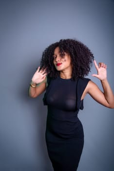 Beautiful young woman relaxed and happy against gray background. studio portrait