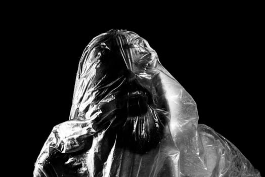 Man with plastic bag over his head, suffocated. Black and white shot. pain expression.