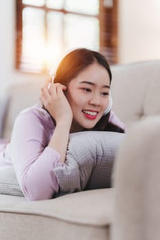 Attractive Asian woman resting comfortable living room and using mobile phone, Relax, Sofa, Lifestyle.