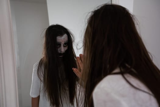 scary girl in white dress from horror film in room.