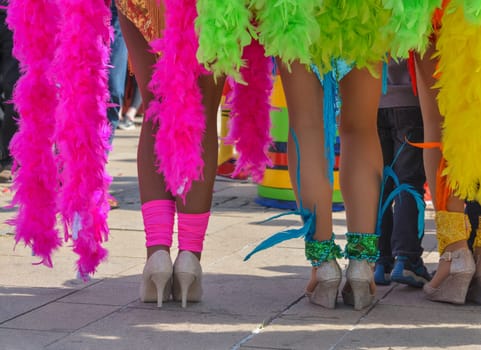 The beautiful legs of women dancers of the Pacific and caribbean beach